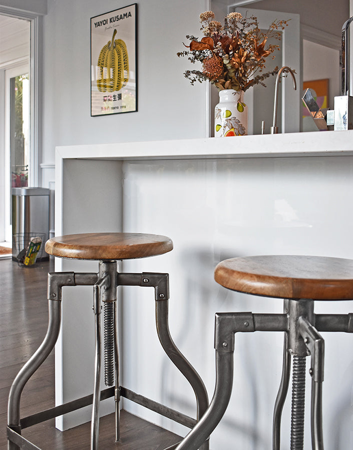 2 vintage nickel bar stools under a kitchen island