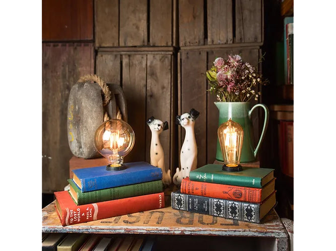 2 Vintage 3 Book Stack Lamps with a big illuminated bulb and skinny long bulb