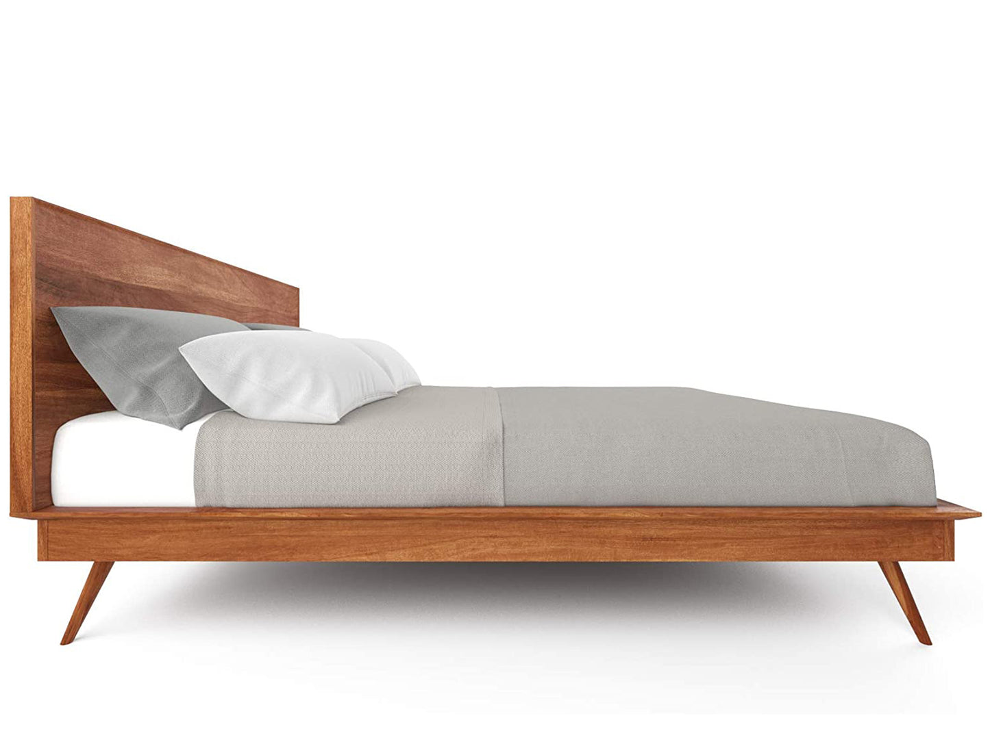 Low side angle of King Sized Scandinavian Bed, showing legs and frame with a mattress and pillows