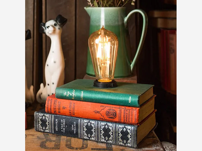 Close up Antique 3 Book Stack Lamp and skinny long bulb