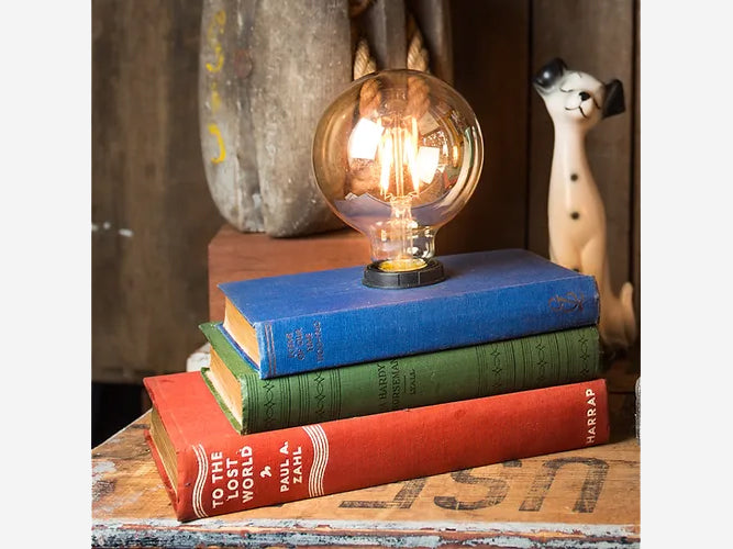Upswitch 3 Book Stack Lamp with large illuminated bulb