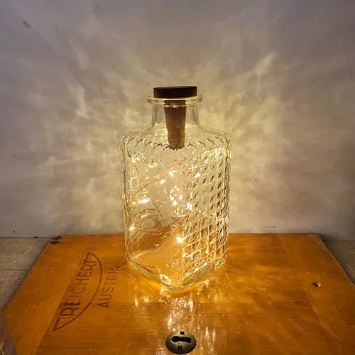 Cork lights in a gin jar lluminated
