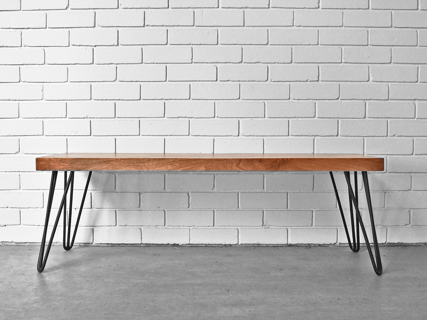 Front view Hairpin Leg Bench against Brick Wall